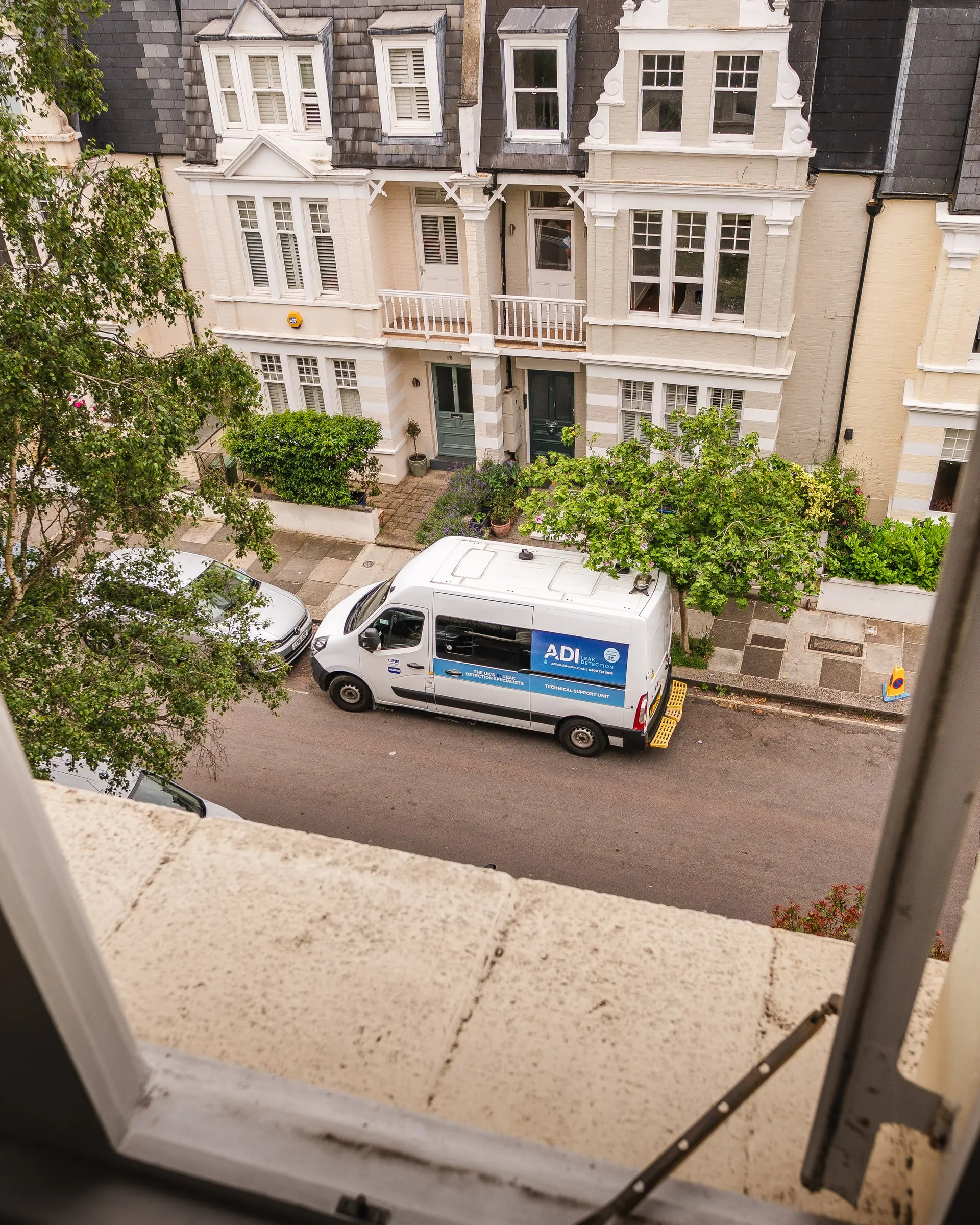 ADI van parked on a street, seen from an upper window
